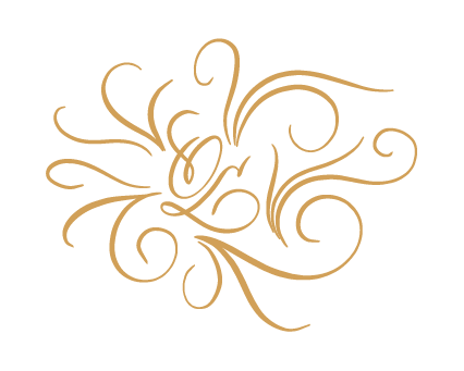 Hand-drawn monogram in golden script with delicate flourishes and curls, on a cream ground.
